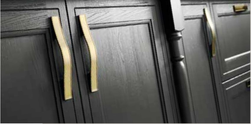 Gold handles on black doors